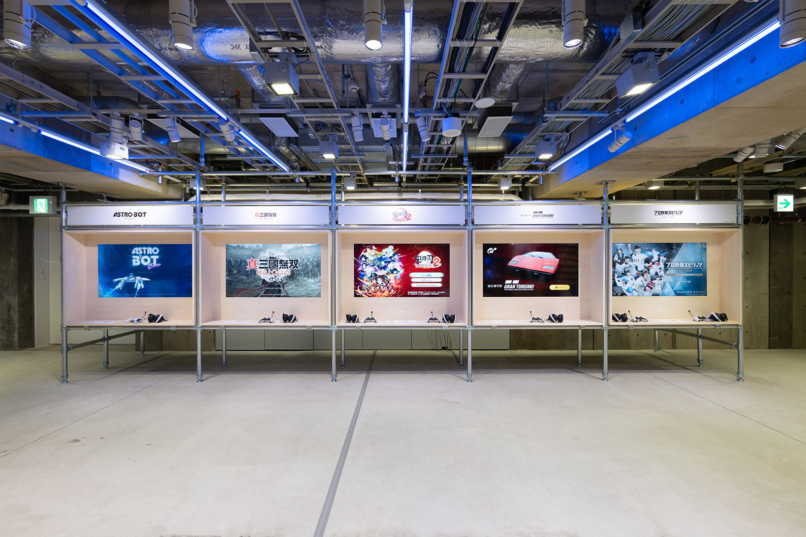 Photo of the B2 game corner, featuring screens of five playable titles: 'ASTRO BOT', 'DYNASTY WARRIORS: ORIGINS', 'Demon Slayer -Kimetsu no Yaiba- The Hinokami Chronicles 2', 'My First Gran Turismo', and 'Professional Baseball Spirits 2024-2025'. 