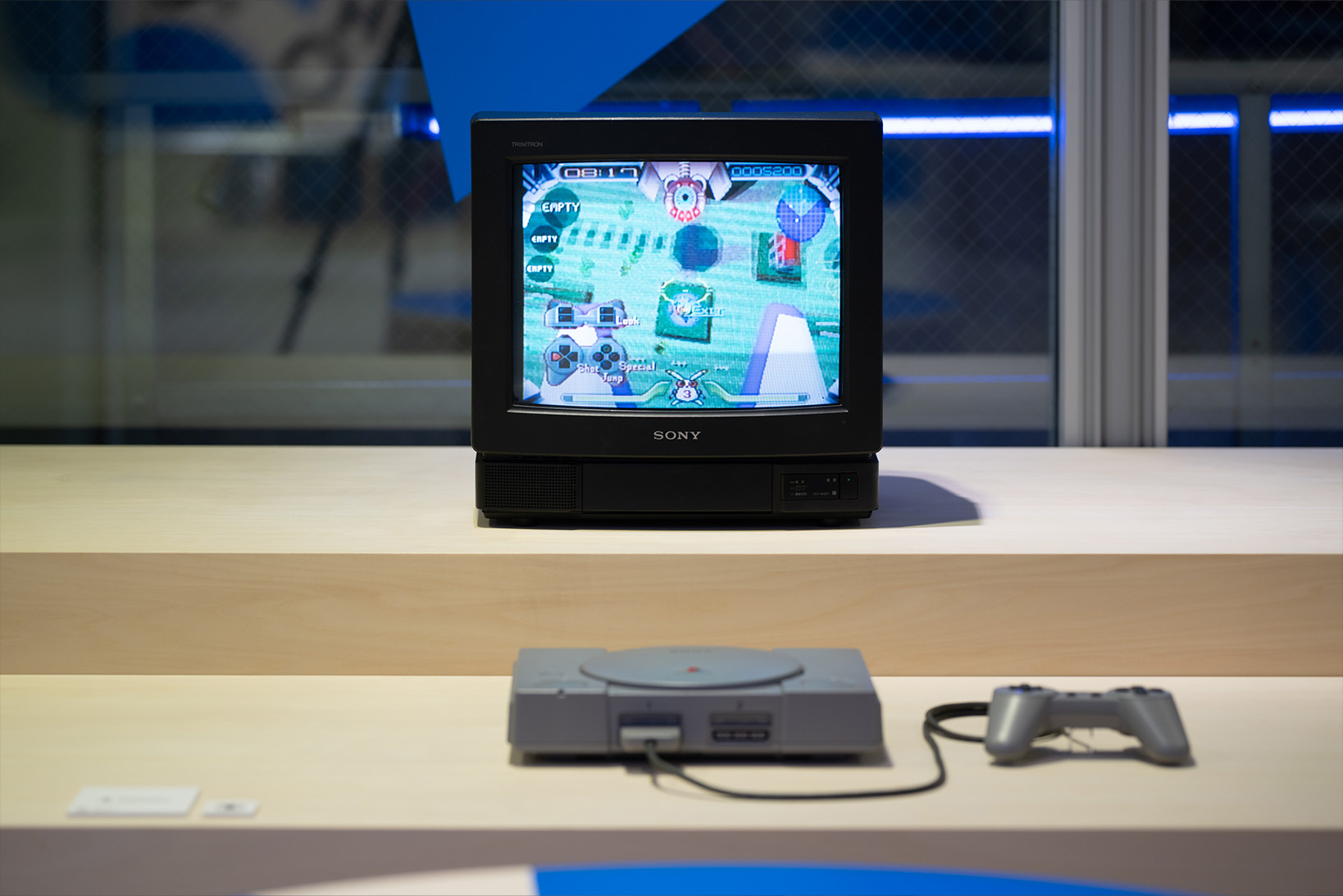 Photo of the B2 archive corner, featuring the hardware of the original PlayStation alongside a television from that time.